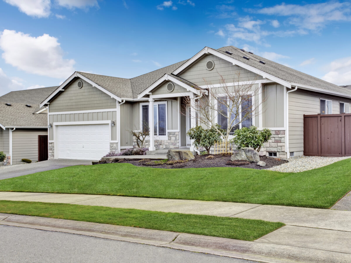 House exterior. View of entrance porch with walkway and garage with driveway